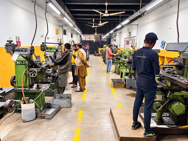 Milling machines and operators on the factory floor
