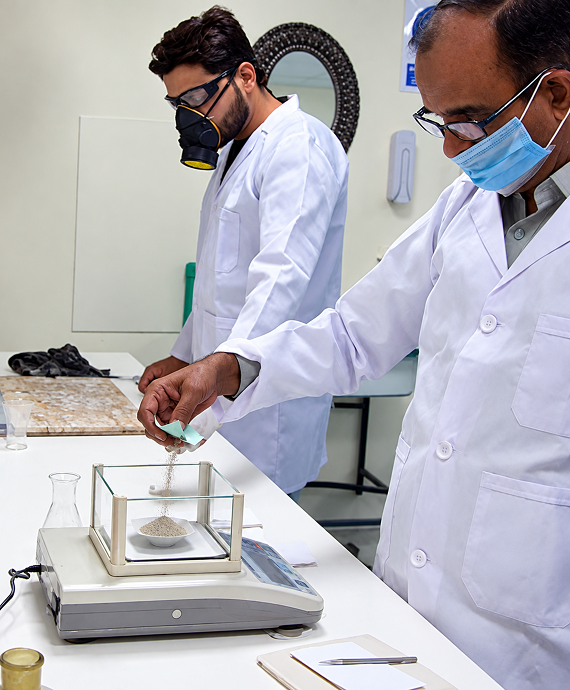 Quality control staff weighing instrument samples in the lab